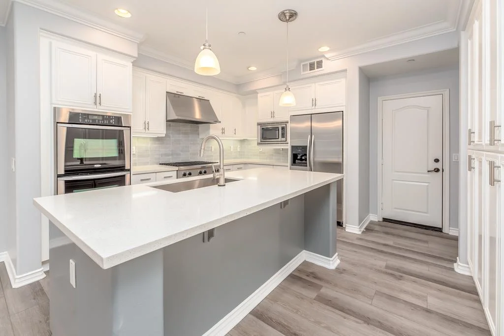 Contact Us. L-shaped white quartz kitchen countertops with professional installation in Vernon.